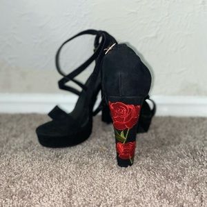 Size 9 black heels with rose detail on the back.